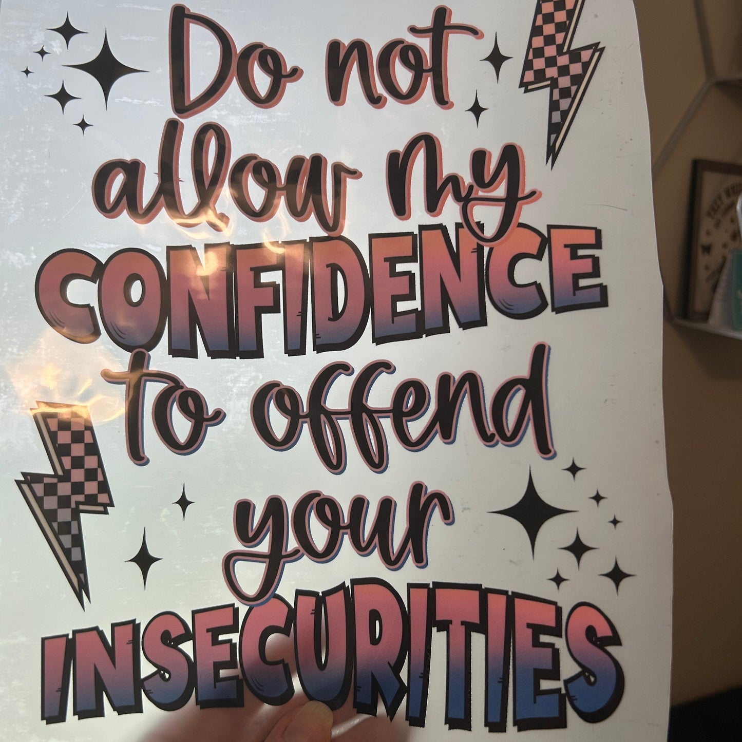 Handwritten motivational quote on a piece of paper held by a person.