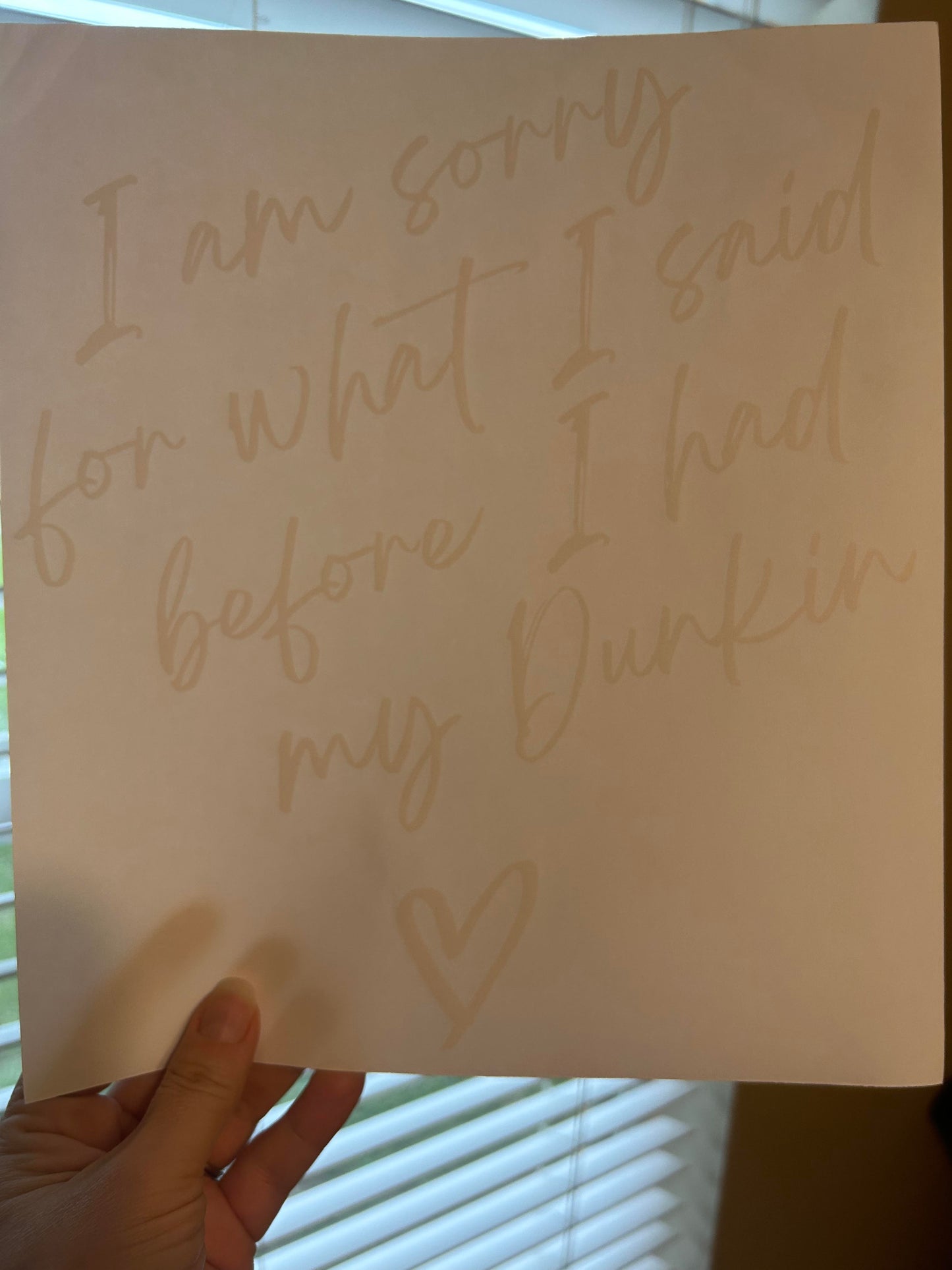 Handwritten note on a piece of paper held by a hand, with text and a heart symbol.