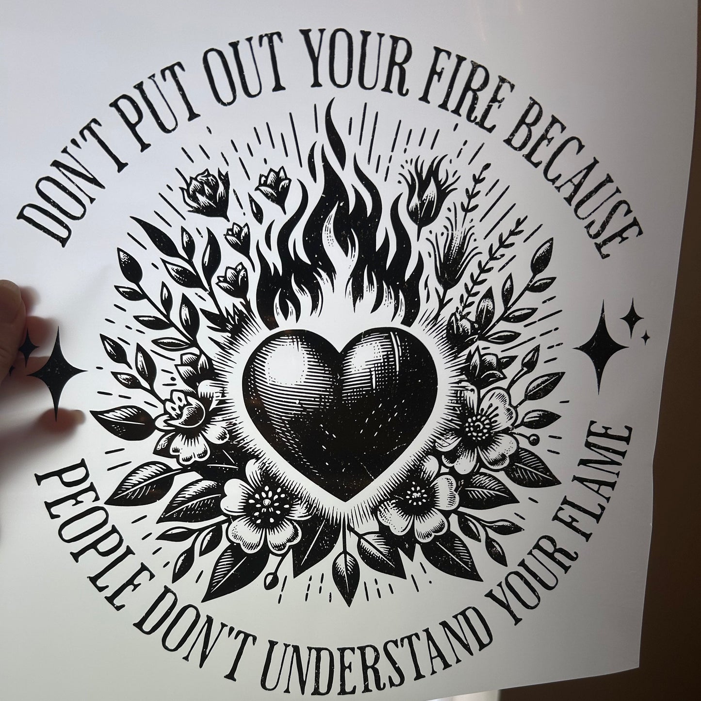 Decorative poster with black and white design and text on a light surface.