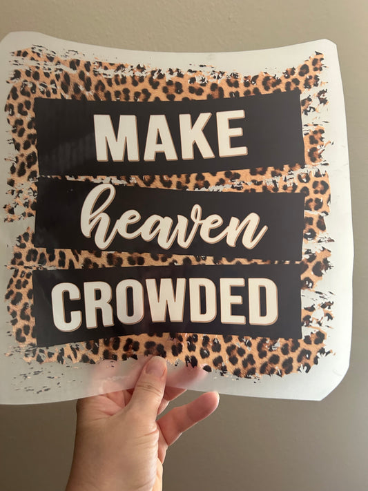 Decorative pillow with leopard print and text held by a hand against a neutral background