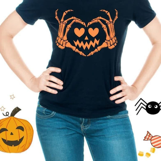 Person wearing a black t-shirt with a Halloween-themed design, surrounded by festive illustrations.