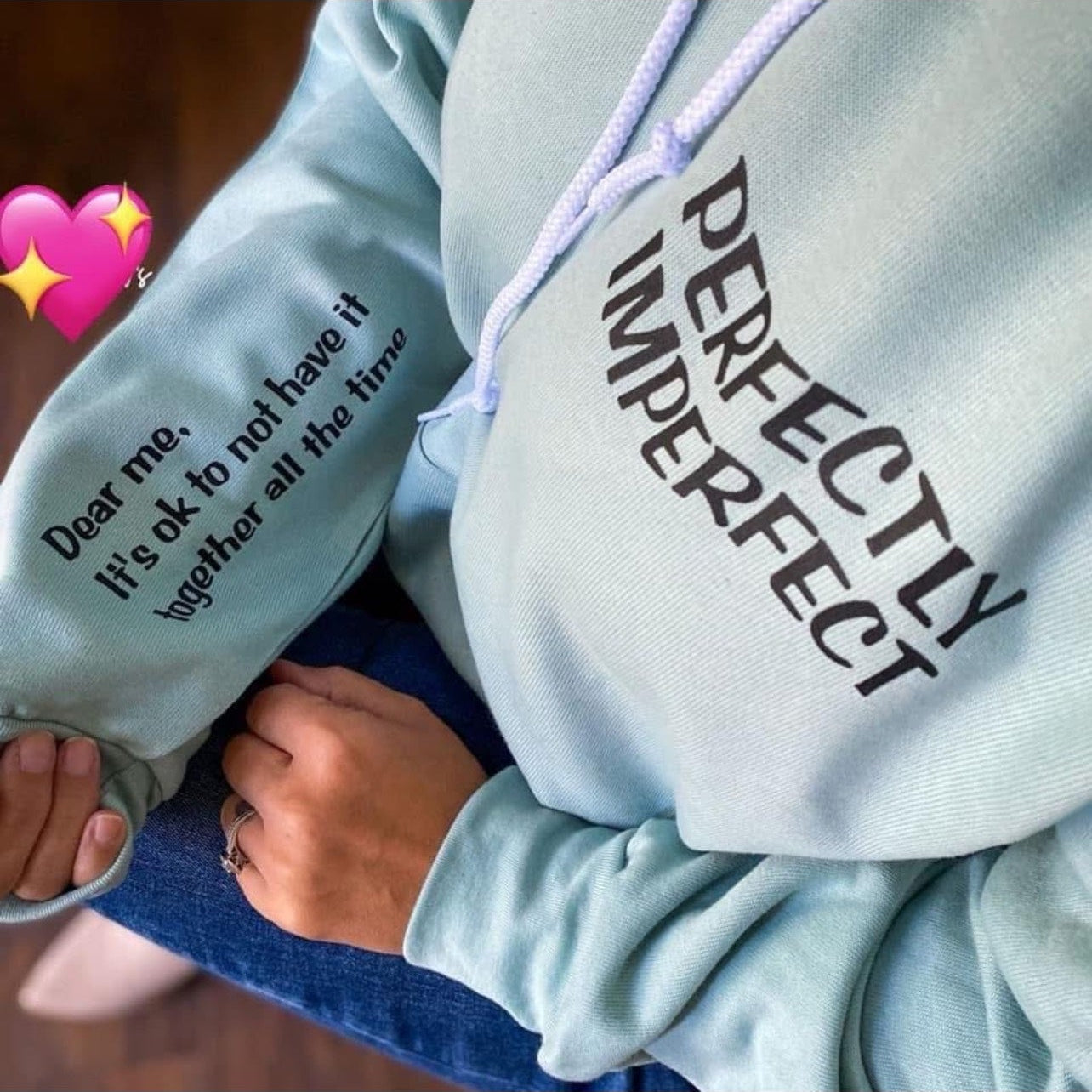 Light blue hoodie with 'PERFECTION' text on a dark background