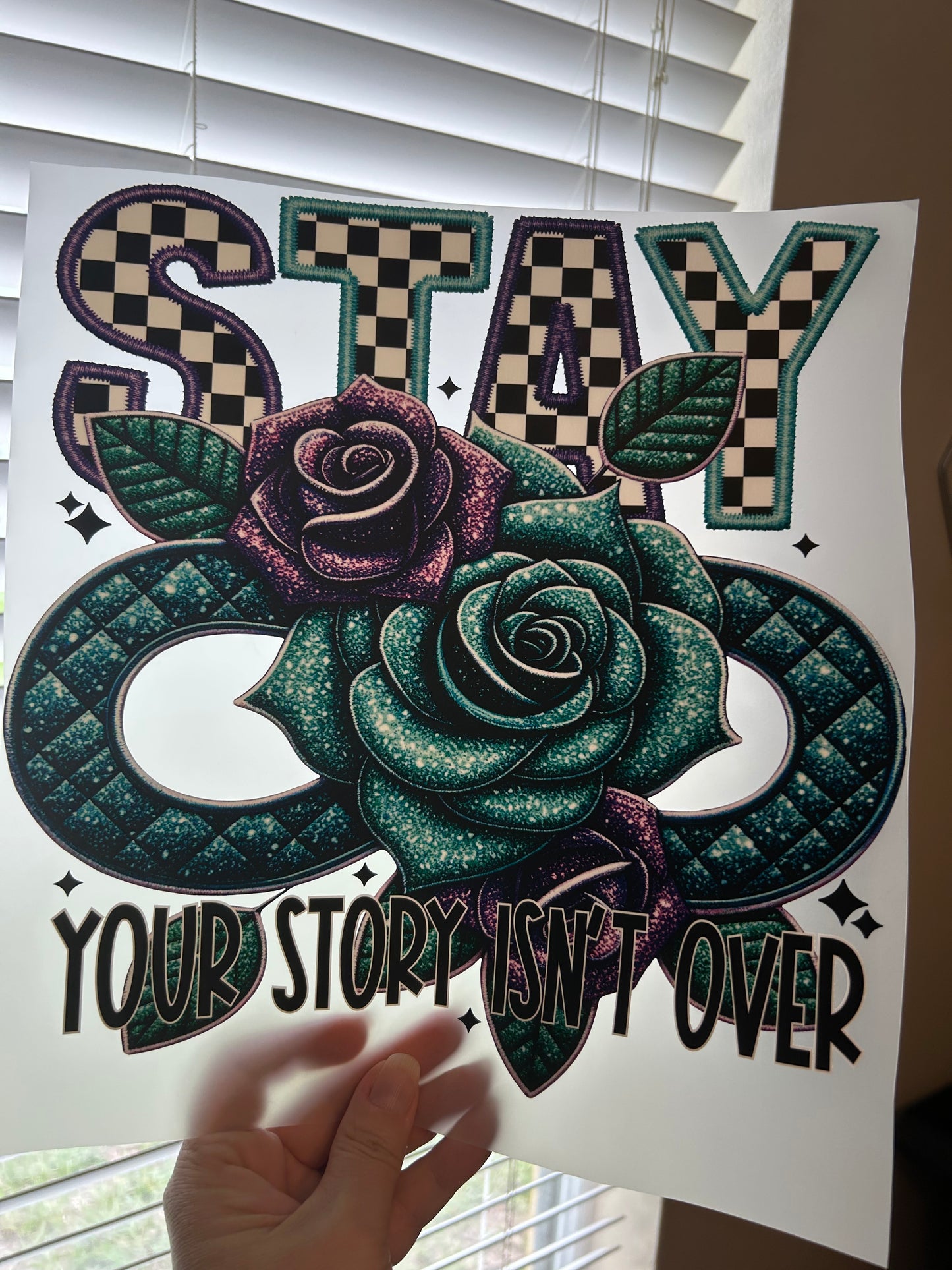 Decorative paper cutout with floral design and text on a white background
