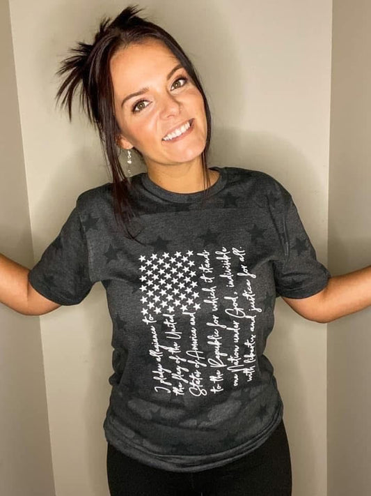 Woman wearing a black t-shirt with a white text design against a plain background